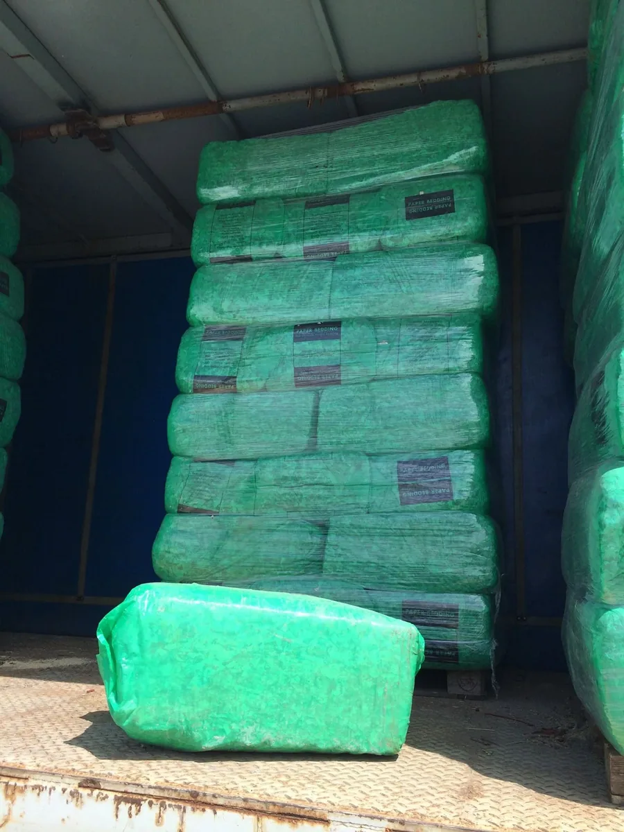 Pallet of green-wrapped Paper Bedding bales — highly absorbent shredded paper bedding for horses